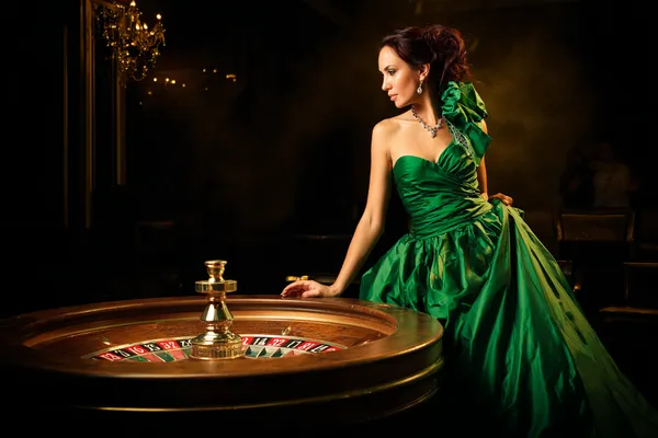 A stylish woman beside vibrant slot machines displaying glowing sevens, showcasing the variety of top slots at JILI7978.
