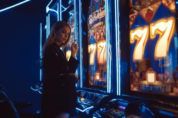 A woman smiling by bright slot machines showing lucky symbols, showcasing the exciting slot offerings at JILI7978.